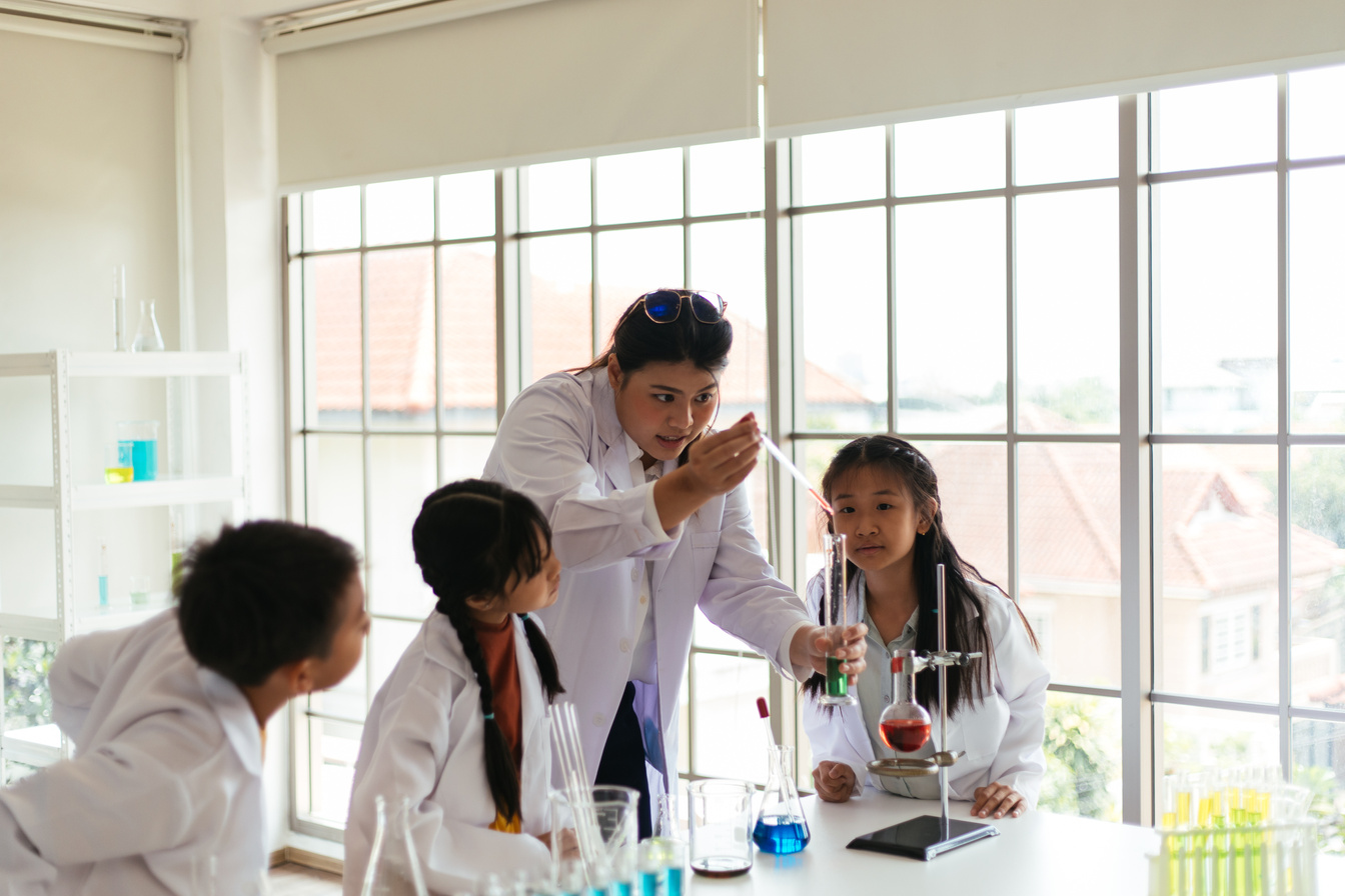 Students Observing Teacher In Science Class